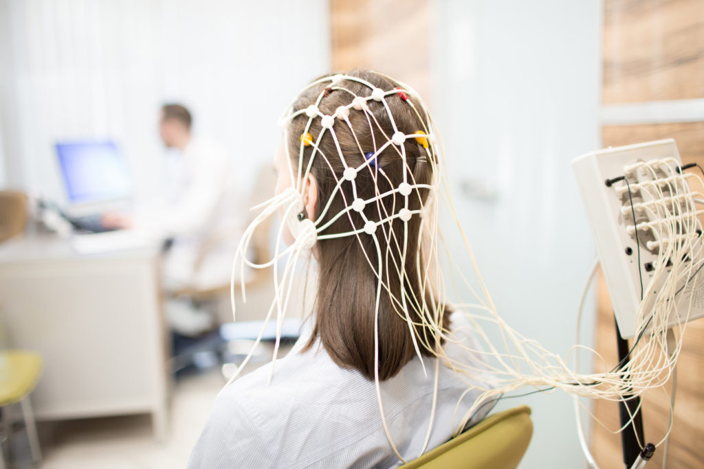 Woman attached to EEG while practicing nadi shodhana 